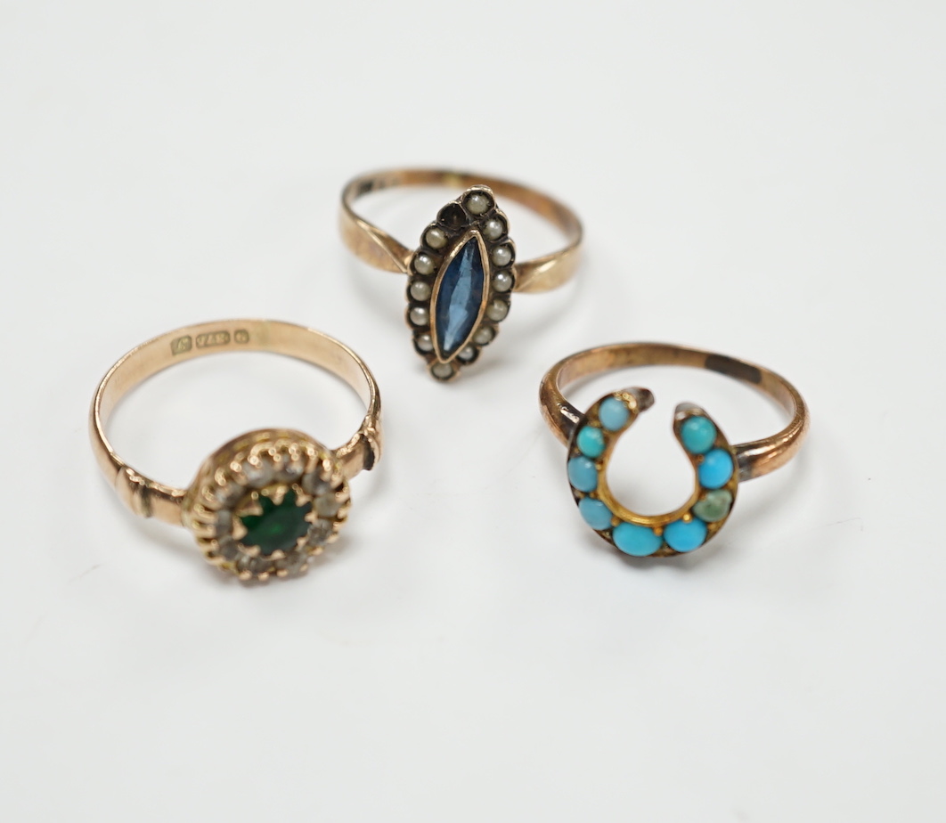 An early 20th century 9ct gold and two colour pastes set circular cluster ring, a 333 (8ct) ring and one other yellow metal and turquoise set horseshoe ring, gross weight 5.6 grams.